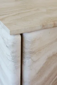 A close-up view of a modern marble console table showcasing its sleek, curved design.