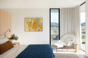 Modern minimalist bedroom featuring wood, fabric, and glass materials and design elements.