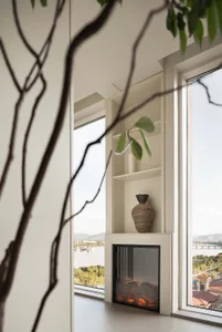 Modern ceramic vase sitting on a white console table in a living room.