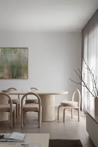 Modern dining room with marble table and minimalist design.