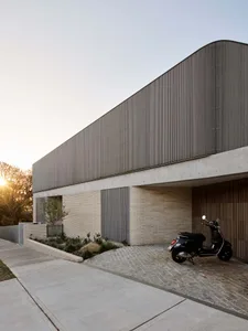 A modern exterior residential entrance featuring a concrete facade and minimalist design.