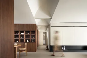 A modern minimalist residential interior with white walls and wooden finishes.