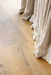 Close-up photo of white modern tiles on a wooden floor