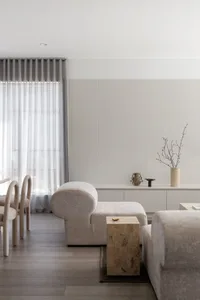 A minimalist living room featuring neutral fabrics and a modern, clean design.