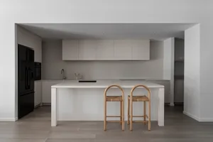 Modern residential kitchen with matte grey cabinets and metallic accents