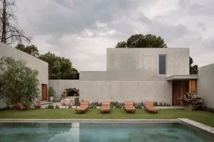 A modern, minimalist exterior with a concrete exterior and a swimming pool.