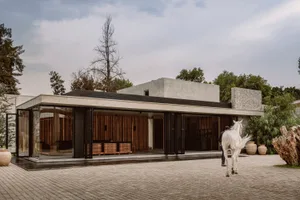 Modern minimalist home exterior featuring concrete and glass materials.