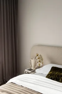 Beige upholstered headboard in a minimalist bedroom