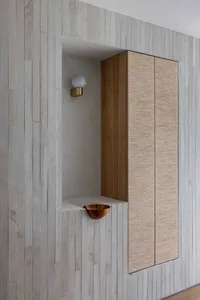 Modern industrial-style corner cabinet featuring a concrete finish, designed with minimalist aesthetic and functional storage