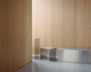 Minimalist design featuring metallic stools in an interior space.