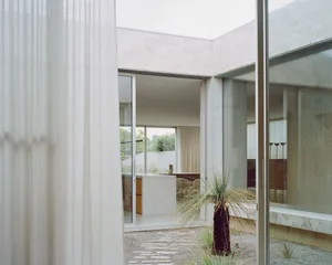 Modern interior design featuring glass and concrete materials.