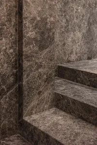 Minimalist staircase made of polished marble, showcasing contemporary design principles with an accent on natural materials.
