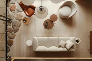 A modern interior living room with parquet flooring featuring a sofa, armchairs, coffee table, and decorative elements such a
