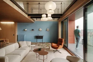 Modern living room with wooden furniture, glass coffee tables, and minimalistic decor.