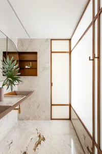 A modern bathroom featuring marble walls and flooring with minimalist design elements.