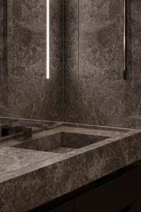 Modern bathroom with grey marble walls and a built-in sink.