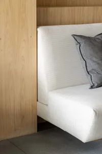 A minimalist interior with a white cushioned seating area.