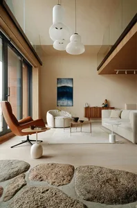 A minimalist living room with neutral materials and a low-light, serene atmosphere.