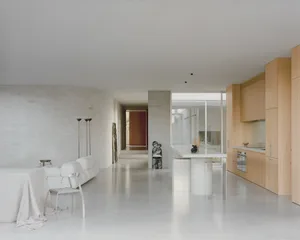 Minimalist residential kitchen with concrete flooring, minimalist furniture, and sleek, modern design.