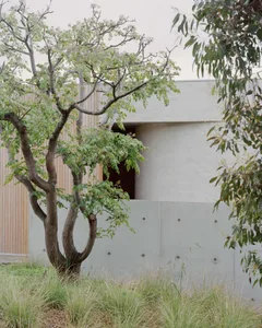 A modern residential exterior featuring concrete as the primary material.