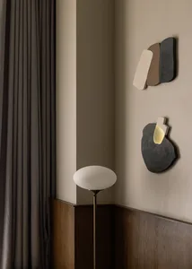Modern interior design featuring abstract concrete art pieces on the wall.