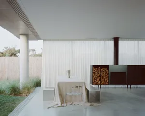 A minimalist interior featuring a concrete floor and walls.