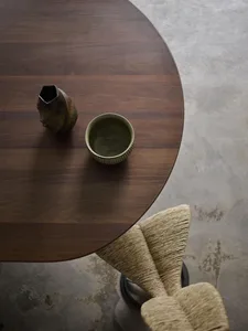 A modern wooden table with a vase and bowl on it, viewed from above.