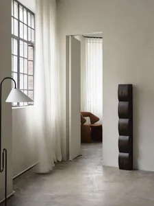 A modern living room featuring a minimalist design with wood grain elements.