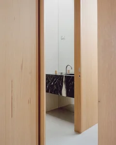 Modern minimalist bathroom featuring marble countertop and flooring.