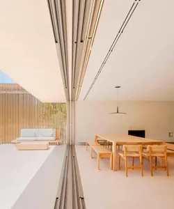 A minimalist residential interior designed with wood and white materials.