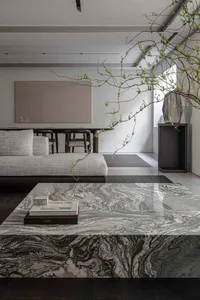 Modern, minimalist living room featuring marble furniture and minimalist decor.