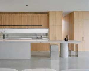A modern residential kitchen with wooden cabinets and a white countertop.