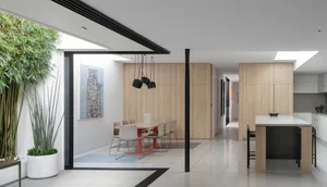 A modern residential interior featuring wood and glass materials.
