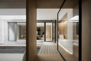 A minimalist living room with wooden floors, showcasing a clean and modern design.