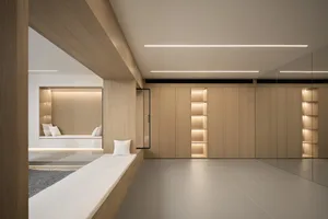 A modern minimalist living room with wood elements and built-in shelves.