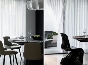 Modern dining room with black table, white chairs, and a glass chandelier.