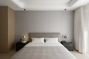 Neutral-toned bedroom featuring a minimalist layout with a clean, uncluttered design.