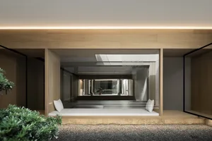 Contemporary minimalist living room with a wooden lounging area featuring a cushioned bench and small plant.