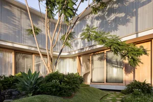 A modern residential exterior featuring large windows, wooden accents, and a landscaped garden.