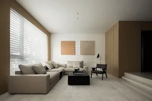 A minimalist living room with a neutral color palette.