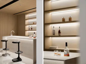 Modern bar with a concrete countertop and sleek stools.