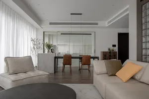 A modern living room with a neutral color palette and minimalist design.