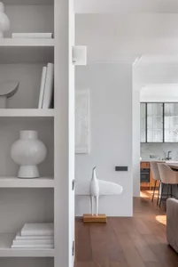 Modern living space featuring a minimalist interior with neutral tones and wooden flooring.
