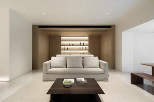 Modern minimalist living room featuring neutral-toned materials and a sleek, open design.
