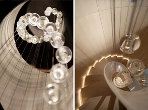 Glass chandelier hanging from a spiral staircase