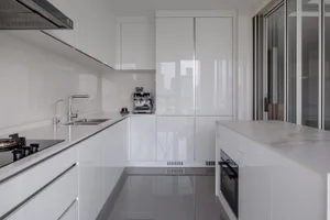 Modern kitchen interior with white cabinets and appliances