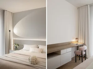 A minimalist bedroom with neutral materials and a large window.