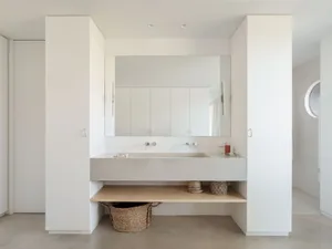 Modern minimalist bathroom with concrete sink, minimalistic design, and clean lines.