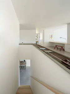 A modern workspace with concrete flooring, minimalist decor, and a sleek, industrial aesthetic.