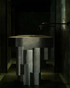 A modern bathroom featuring a marble countertop with integrated sink and minimalist design elements.